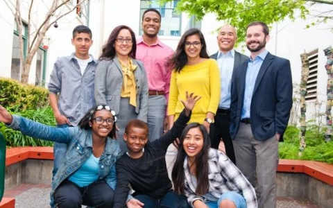 Smiling teachers and students posing for photo