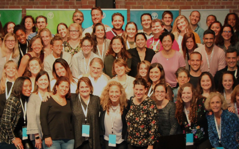 Schusterman staff smiling group photo