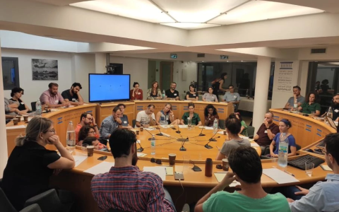 A group of people at table discussing policy
