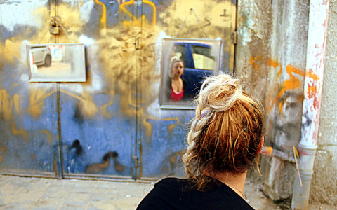 Woman looks at art installation