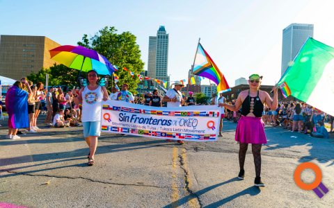Advancing Equal Rights, two people draped in a rainbow flag