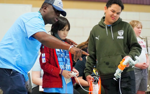 Preparing Youth for a STEM-Enabled Future, Students looking through microscope