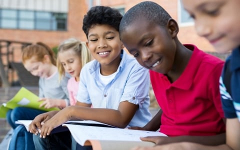 Elementary students reading - School System Partnerships